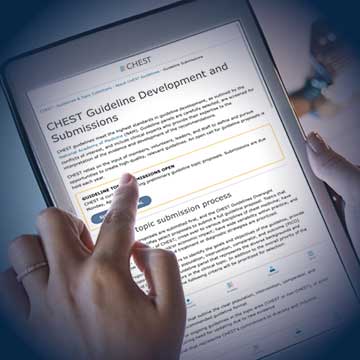 A person's finger points to the CHEST Guideline Development and Submissions web page displayed on a tablet