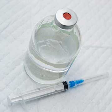 A vial with a clear solution and syringe